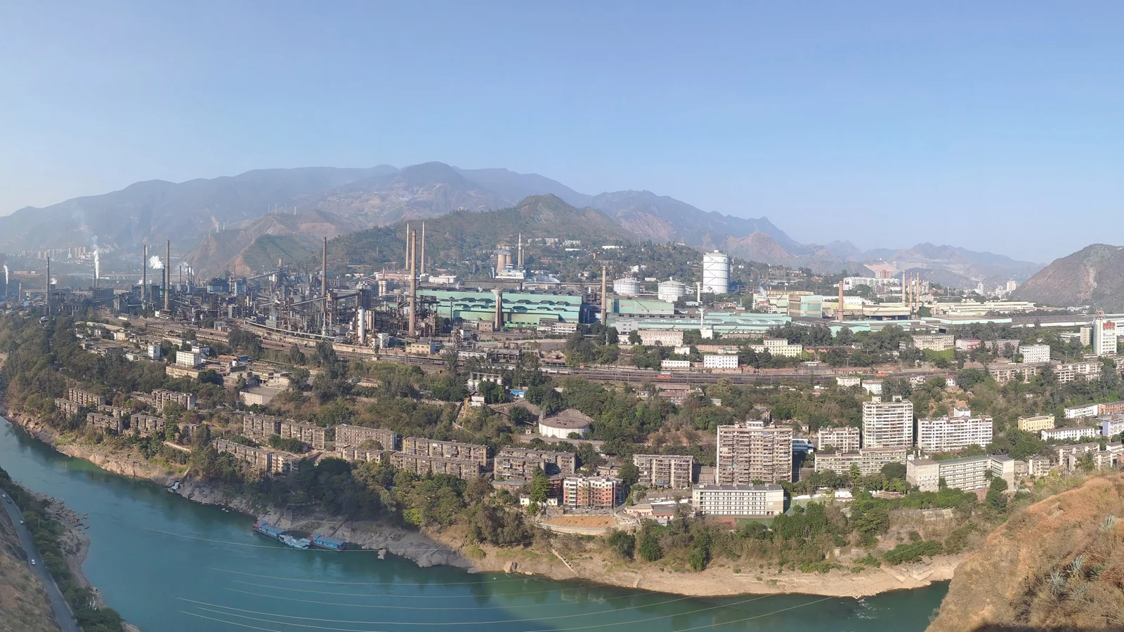 Main plant of Pangang Group's Panzhihua Iron and Steel in Panzhihua, Sichuan, China, with blast furnaces and rolling mills along a river valley