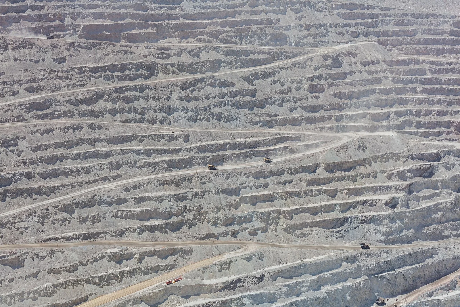 Haul trucks on the terraced benches of the Chuquicamata open-pit copper mine near Calama, Chile
