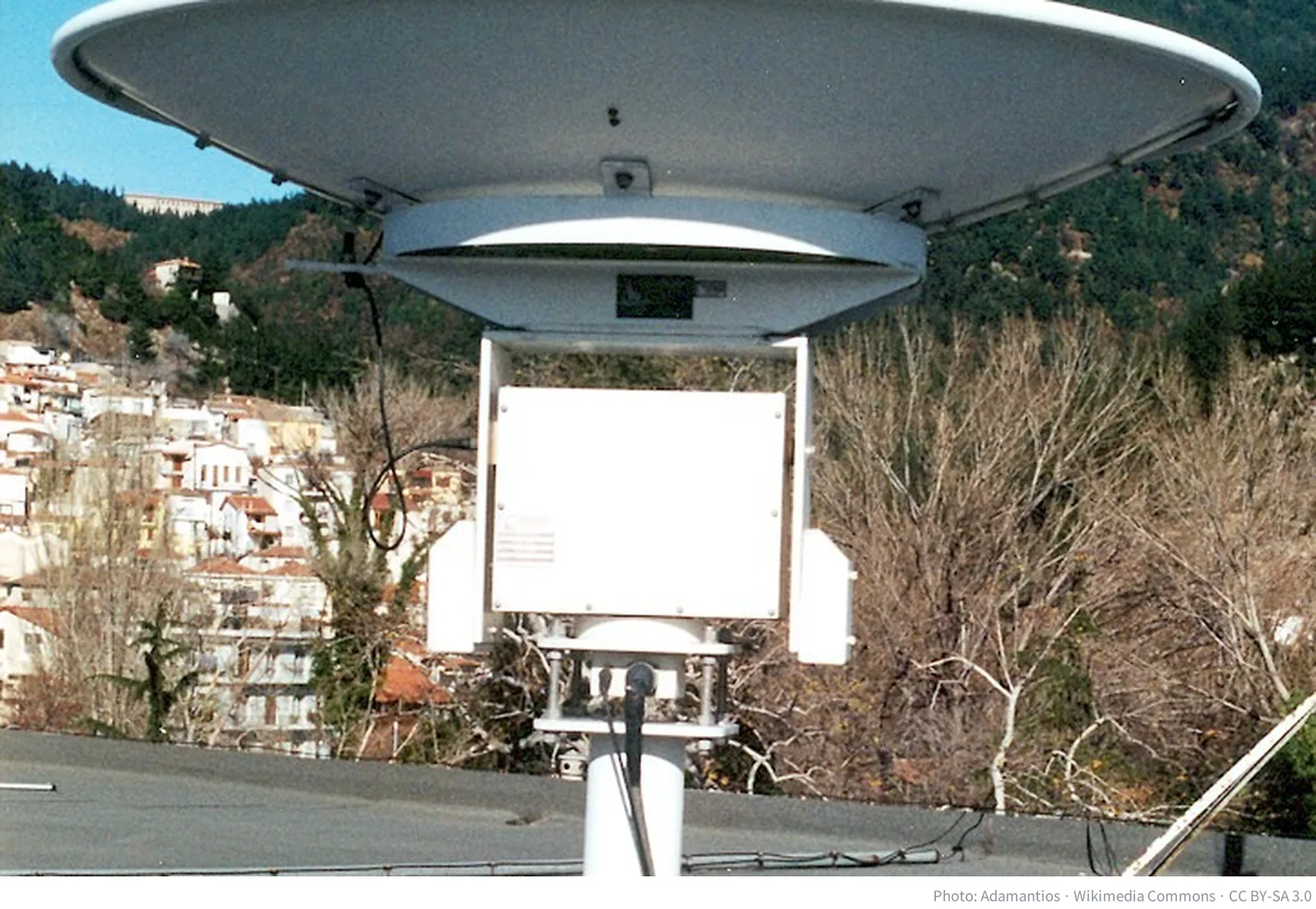 A parabolic dish antenna tracking low Earth orbit satellites at a ground station