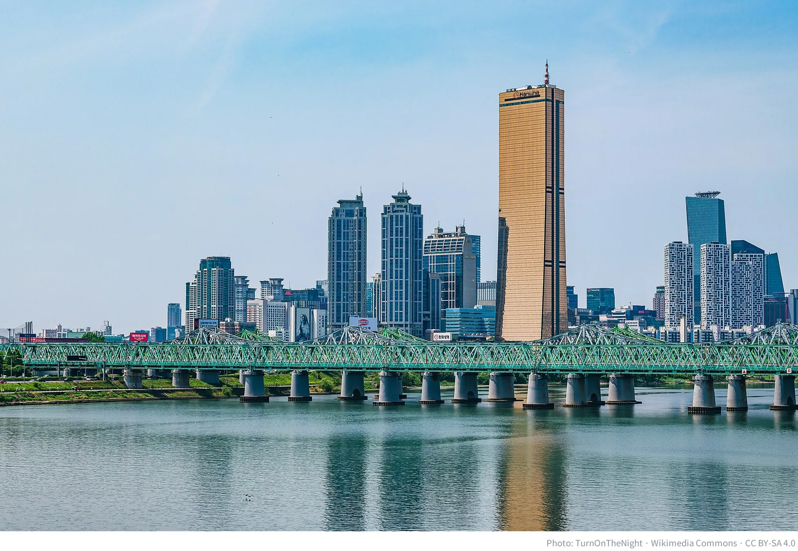 Yeouido skyscrapers and the Hangang Railway Bridge in Seoul, photographed on May 1, 2024 (Wikimedia Commons)