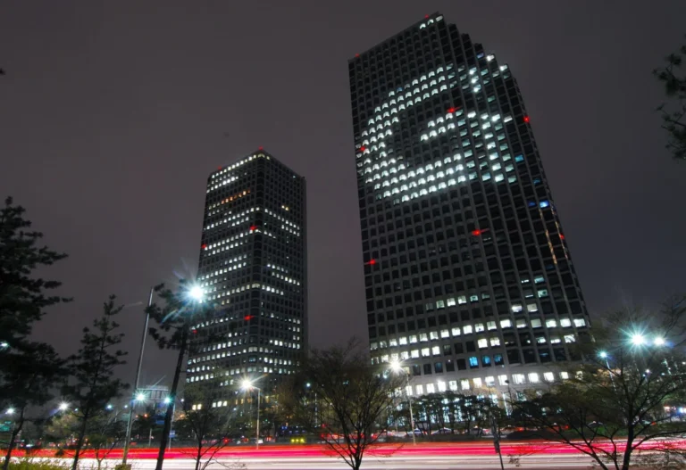 The LG Twin Towers in Yeouido, Seoul, where LG Chem has its headquarters, at night with a 'G' lit in the windows of one tower