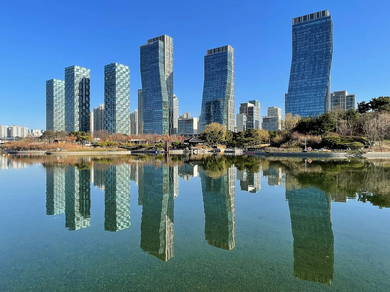 Skyscrapers of Songdo, Incheon, reflected in the lake of Songdo Central Park on a clear day.