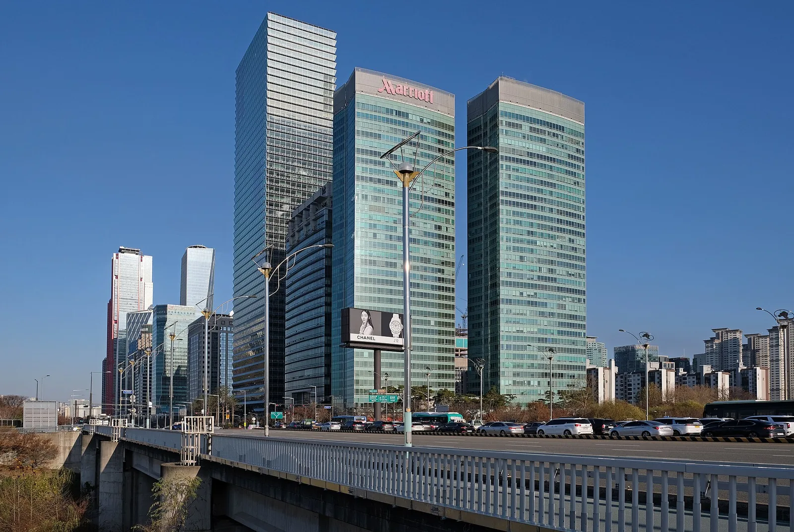 IFC Seoul office towers in Yeouido, Seoul's financial district, seen from a bridge on a sunny day.