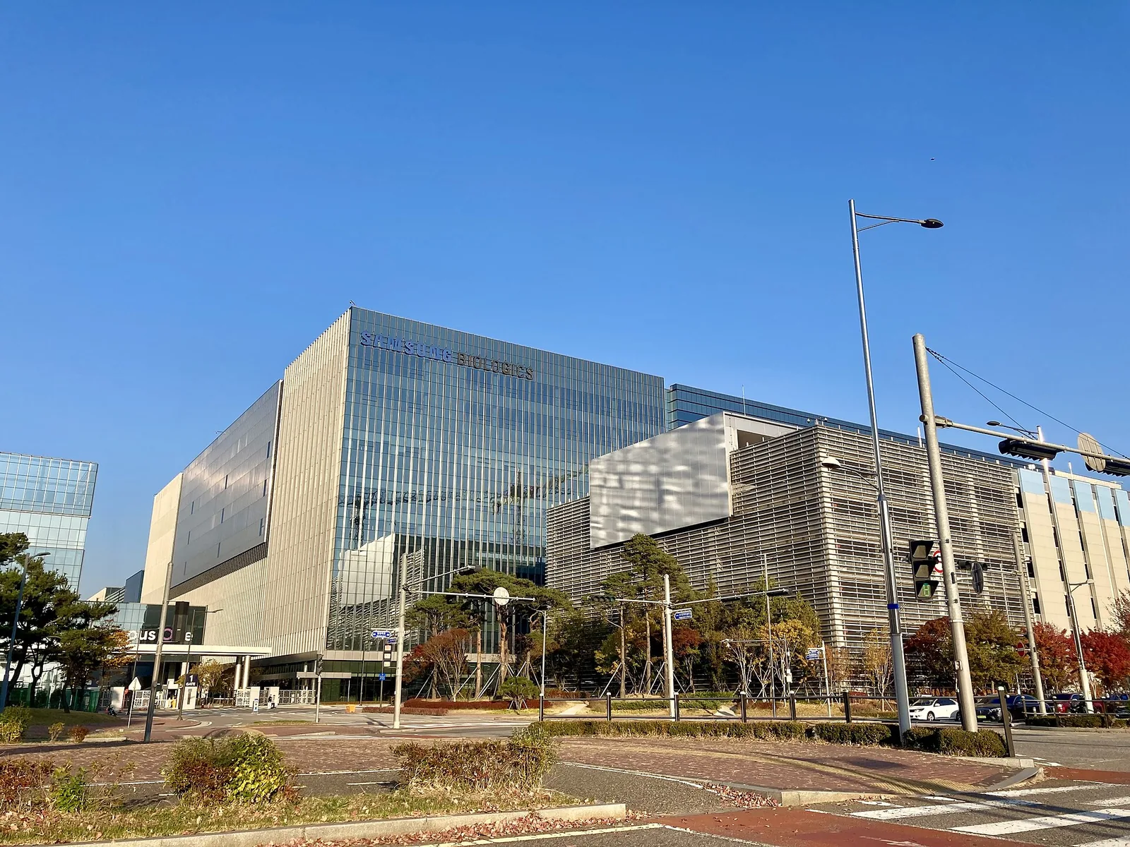 Samsung Biologics building in Songdo, Incheon, with the company name on its glass facade.