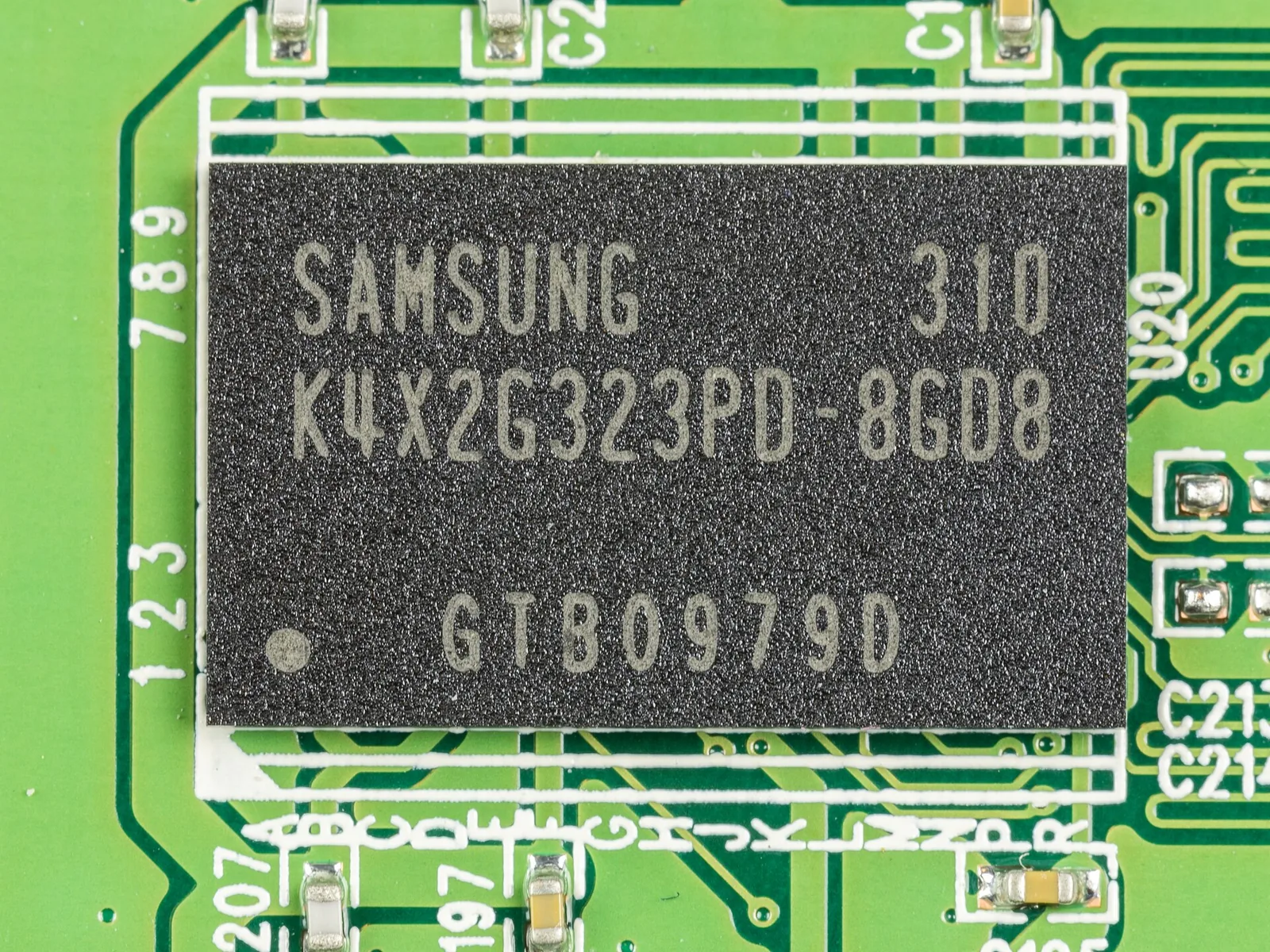 Close-up of a Samsung K4X2G323PD mobile DRAM memory chip mounted on a green circuit board.