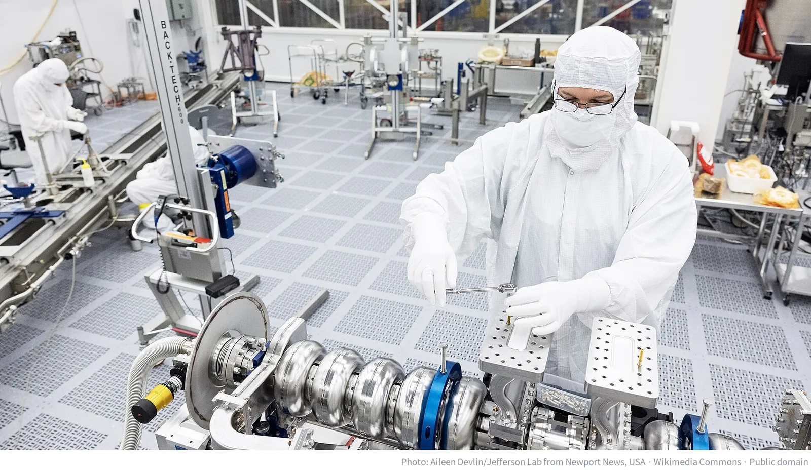 A technician working inside a clean room at Jefferson Lab